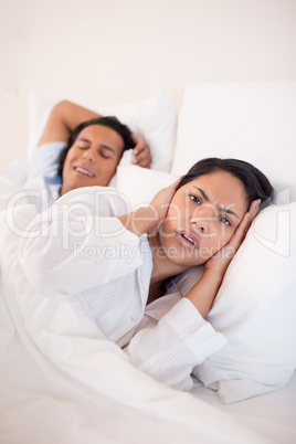 Woman being annoyed by snoring boyfriend