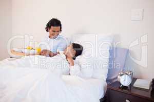 Man brought breakfast to the bed for his girlfriend