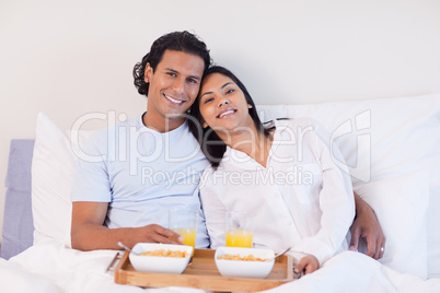 Couple enjoying breakfast in the bed