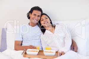 Couple enjoying breakfast in the bed