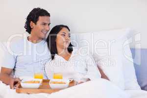 Couple having breakfast in the bed