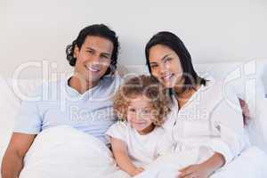Family sitting on the bed