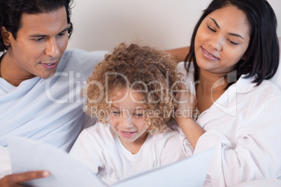 Happy family enjoys reading a book