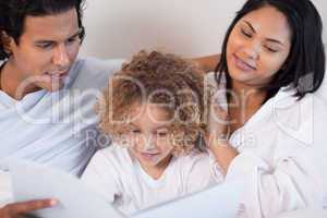 Happy family enjoys reading a book