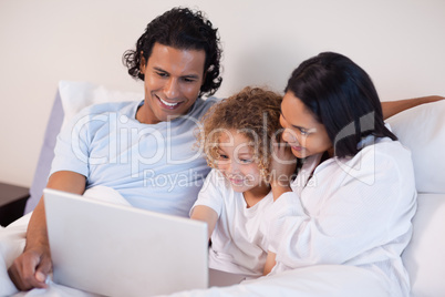 Family in the bedroom surfing the internet