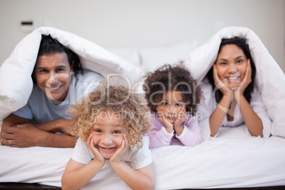 Family playing in the bedroom together