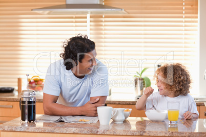 Father and daughter having breakfast in the kitchen