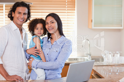 Family surfing the web in the kitchen together