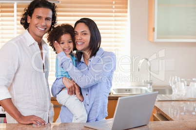 Family surfing the internet in the kitchen together