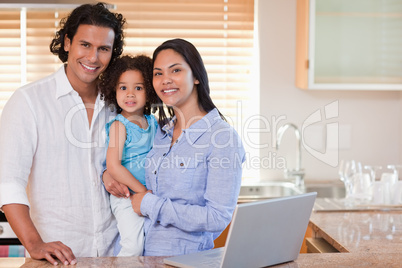 Smiling family together in the kitchen