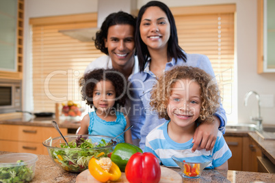 Family preparing salad together