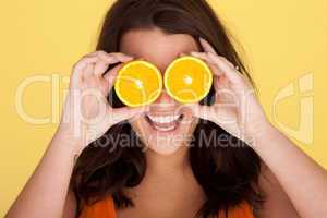Laughing Woman With Orange Slices Over Eyes