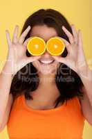 Joyful Woman With Orange Slices Over Eyes