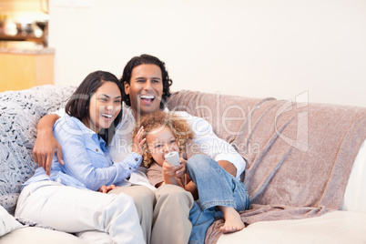 Happy family watching television together