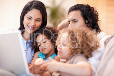 Happy family using laptop together