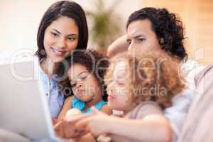 Happy family using laptop together