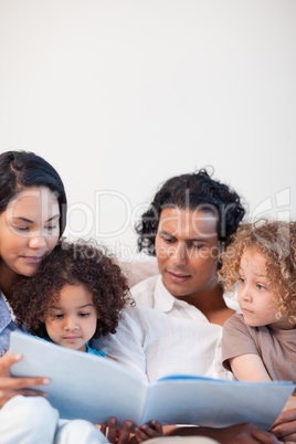 Family on the sofa having a look at a photo album together