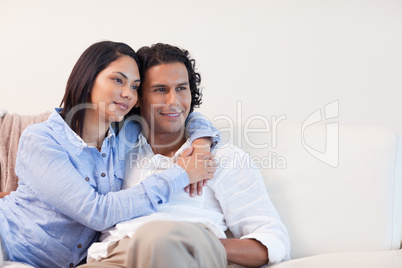 Couple on the couch hugging