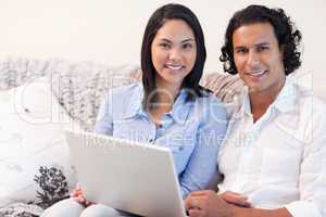 Couple with laptop on the sofa
