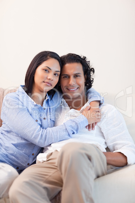 Couple on the couch embracing