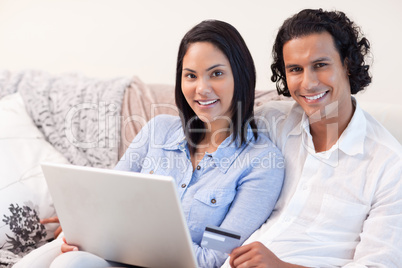 Couple with notebook on the sofa