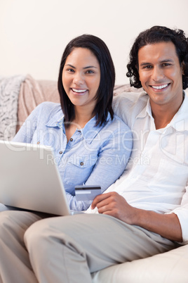 Couple with notebook on the couch