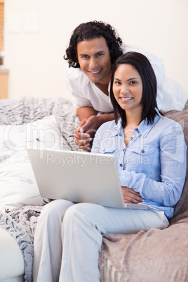 Couple surfing the internet on the couch