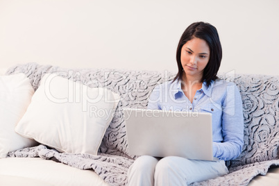 Woman on the sofa surfing the internet