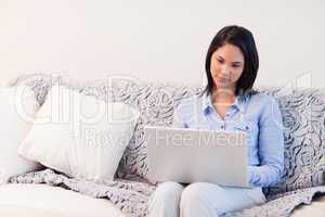 Woman on the sofa surfing the internet
