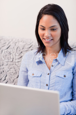 Woman on the couch surfing the internet