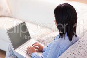 Woman working on her laptop in the living room