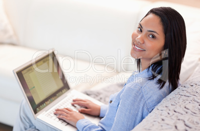 Woman working on her notebook in the living room