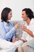 Couple drinking sparkling wine on the sofa