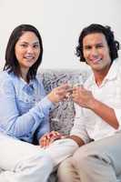 Couple drinking sparkling wine on the couch