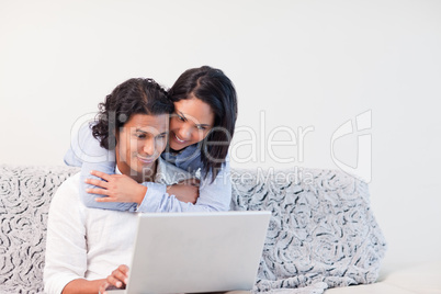 Couple spending time online in the living room together