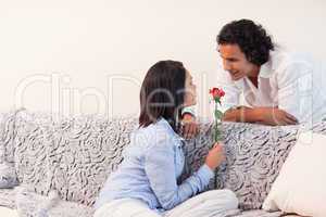 Woman got a rose from her boyfriend in the living room
