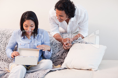 Woman opening the present she got from her boyfriend