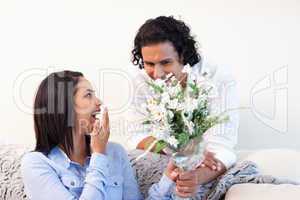 Man giving his girlfriend a bouquet