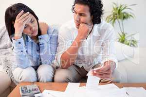 Frustrated couple checking their bills