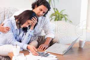 Side view of couple having a hard time paying their bills