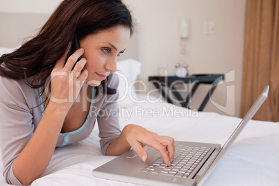 Woman on the phone using laptop
