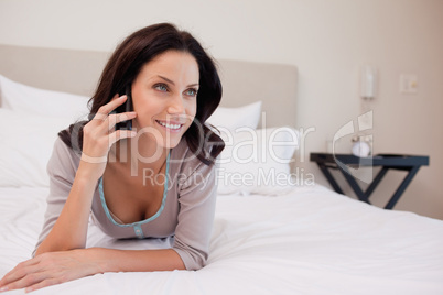 Woman on the bed having a phone call