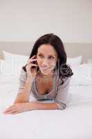 Woman lying on the bed with her cellphone