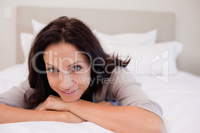 Smiling woman relaxing on the bed