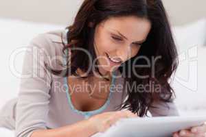 Woman laying on the bed with tablet