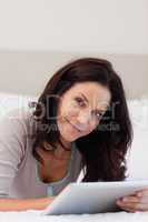 Woman in the bedroom using her tablet