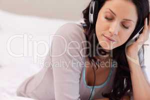 Woman enjoying music in her bedroom