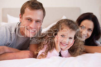 Family relaxing in the bedroom together