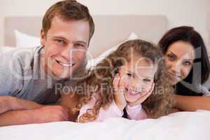 Family relaxing in the bedroom together