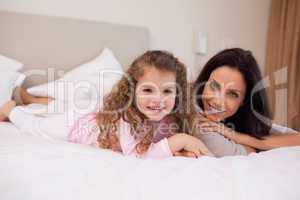Mother and daughter relaxing in the bedroom together